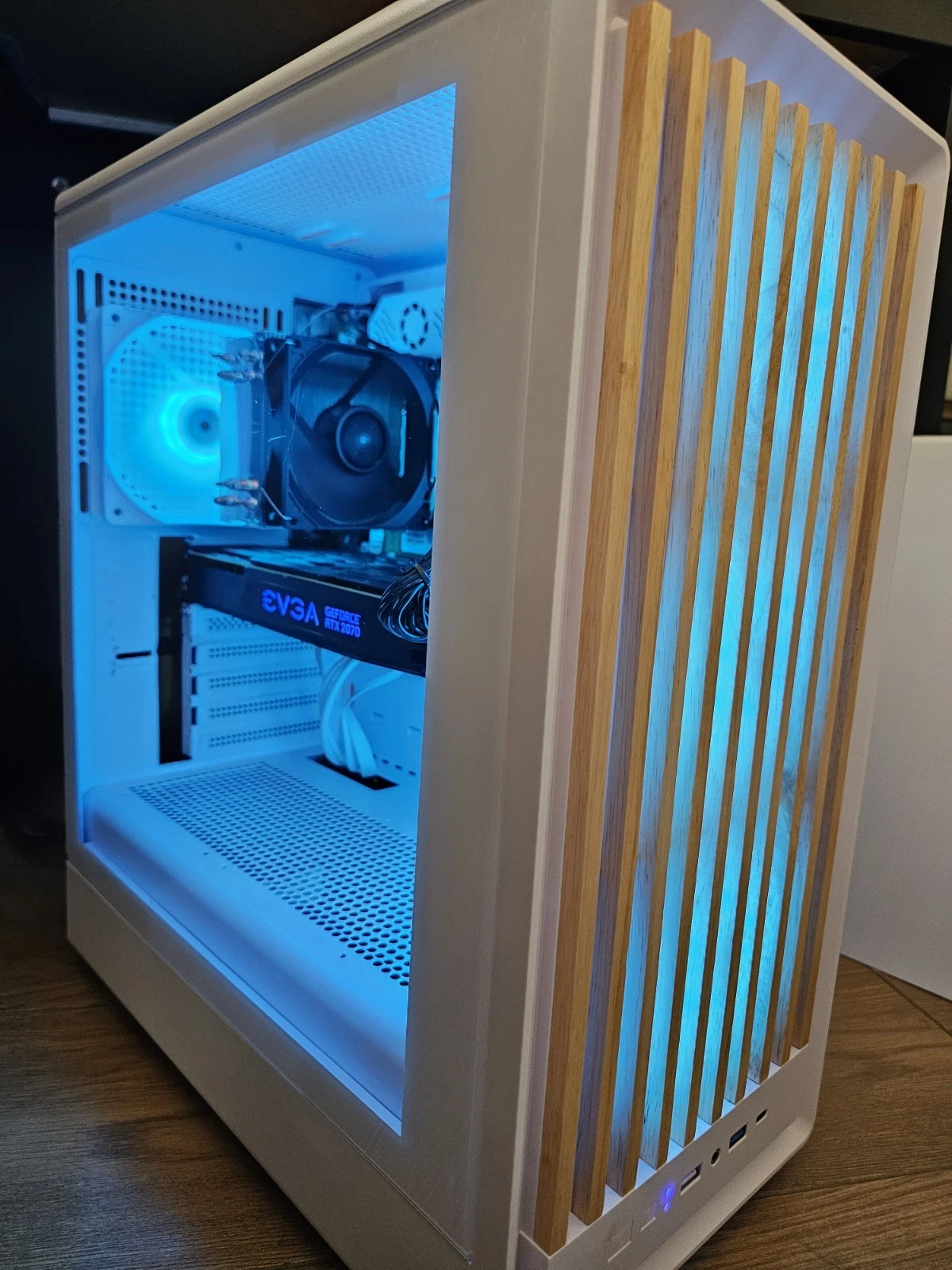 Real white gaming PC with blue RGB lighting